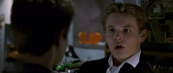 Movie still from “Halloween: Resurrection” (2002), directed by Rick Rosenthal – A young man in a black suit is looking surprised; Close Up shot, Over the shoulder angle