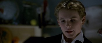 Movie still from “Halloween: Resurrection” (2002), directed by Rick Rosenthal – A young man with blonde hair wearing a black suit; Close Up shot, Over the shoulder angle