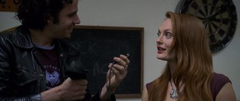 Movie still from “Halloween: Resurrection” (2002), directed by Rick Rosenthal – A man and a woman are holding a microphone; Close Up shot, Over the shoulder angle