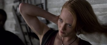 Movie still from “Halloween: Resurrection” (2002), directed by Rick Rosenthal – A beautiful woman with red hair posing for a picture; Close Up shot, Low angle