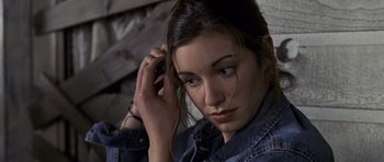 Movie still from “Halloween: Resurrection” (2002), directed by Rick Rosenthal – A young woman is listening to music on her phone; Close Up shot, High angle