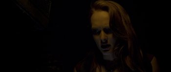 Movie still from “Halloween: Resurrection” (2002), directed by Rick Rosenthal – A woman with red hair is looking at the camera; Close Up shot, Low angle