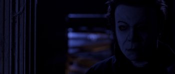 Movie still from “Halloween: Resurrection” (2002), directed by Rick Rosenthal – A person's face in a dark room; Close Up shot, Low angle