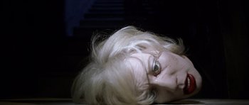Movie still from “Halloween: Resurrection” (2002), directed by Rick Rosenthal – A woman laying on the ground with her eyes closed; Extreme Close Up shot, Overhead angle