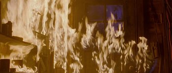 Movie still from “Halloween: Resurrection” (2002), directed by Rick Rosenthal – A bunch of fire is coming out of a window; Close Up shot, High angle