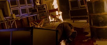 Movie still from “Halloween: Resurrection” (2002), directed by Rick Rosenthal – A man laying on the floor in front of a fire; Wide shot, High angle