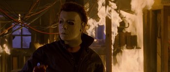 Movie still from “Halloween: Resurrection” (2002), directed by Rick Rosenthal – A person wearing a mask; Close Up shot, Low angle