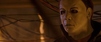 Movie still from “Halloween: Resurrection” (2002), directed by Rick Rosenthal – A person's face in a dark room; Close Up shot, Low angle