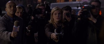Movie still from “Halloween: Resurrection” (2002), directed by Rick Rosenthal – A woman is holding a camera and taking a picture; Medium shot, Over the shoulder angle