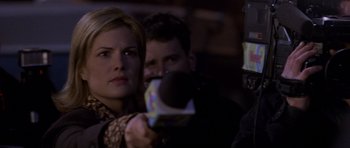 Movie still from “Halloween: Resurrection” (2002), directed by Rick Rosenthal – A man and a woman are holding a microphone; Close Up shot, Over the shoulder angle