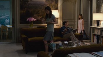 Movie still from “Happy End” (2017), directed by Michael Haneke – Two people are sitting in a living room; Wide shot, Over the shoulder angle