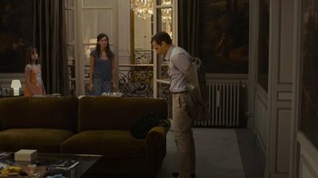 Movie still from “Happy End” (2017), directed by Michael Haneke – A man and a woman in a living room; Wide shot, Over the shoulder angle