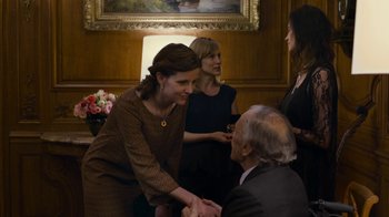 Movie still from “Happy End” (2017), directed by Michael Haneke – Two women and an older man shake hands; Medium shot, Over the shoulder angle