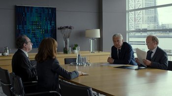 Movie still from “Happy End” (2017), directed by Michael Haneke – Two people sitting at a table in front of each other; Medium shot, Over the shoulder angle