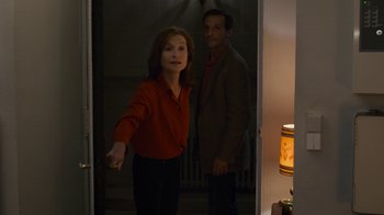 Movie still from “Happy End” (2017), directed by Michael Haneke – A man and a woman standing in front of each other; Medium shot, Over the shoulder angle