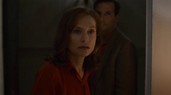 Movie still from “Happy End” (2017), directed by Michael Haneke – A man and a woman standing next to each other in the dark; Close Up shot, Over the shoulder angle