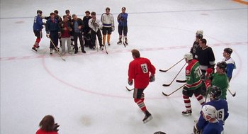 Movie still from “Happy Gilmore” (1996), directed by Dennis Dugan – A group of people standing on top of an ice rink; Wide shot, High angle
