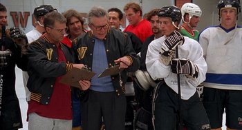 Movie still from “Happy Gilmore” (1996), directed by Dennis Dugan – An older man is writing on a piece of paper; Medium shot, Over the shoulder angle