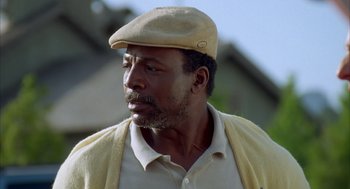 Movie still from “Happy Gilmore” (1996), directed by Dennis Dugan – A person wearing a hat; Close Up shot, Low angle