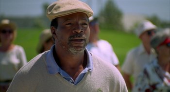 Movie still from “Happy Gilmore” (1996), directed by Dennis Dugan – An older man wearing a hat and sweater; Close Up shot, Low angle