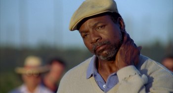 Movie still from “Happy Gilmore” (1996), directed by Dennis Dugan – A person wearing a hat; Close Up shot, Low angle