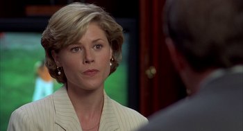 Movie still from “Happy Gilmore” (1996), directed by Dennis Dugan – A person wearing a suit and tie; Close Up shot, Over the shoulder angle