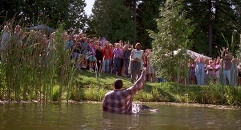 Movie still from “Happy Gilmore” (1996), directed by Dennis Dugan – A group of people standing around a body of water; Extreme Wide shot, High angle
