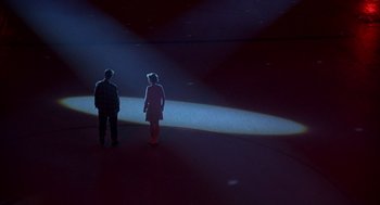Movie still from “Happy Gilmore” (1996), directed by Dennis Dugan – Two people are standing in a dark room; Extreme Wide shot, High angle