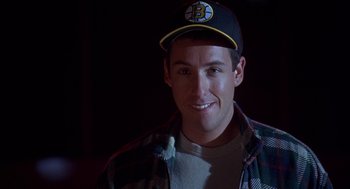 Movie still from “Happy Gilmore” (1996), directed by Dennis Dugan – A man wearing a baseball hat and a plaid shirt; Close Up shot, Over the shoulder angle