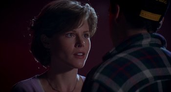 Movie still from “Happy Gilmore” (1996), directed by Dennis Dugan – A young woman talking to a young man in front of a wall; Close Up shot, Over the shoulder angle