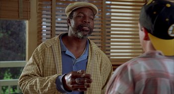 Movie still from “Happy Gilmore” (1996), directed by Dennis Dugan – An older man wearing a hat talking to someone; Close Up shot, Low angle