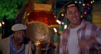 Movie still from “Happy Gilmore” (1996), directed by Dennis Dugan – A man wearing a hat standing next to another man; Medium shot, Over the shoulder angle