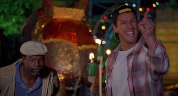 Movie still from “Happy Gilmore” (1996), directed by Dennis Dugan – A man in plaid shirt and hat laughing; Close Up shot, Over the shoulder angle
