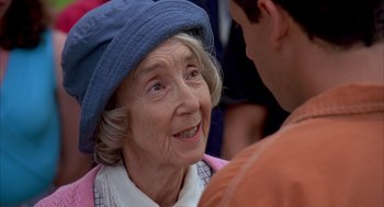 Movie still from “Happy Gilmore” (1996), directed by Dennis Dugan – An older woman wearing a blue hat talking to a younger man; Close Up shot, Over the shoulder angle