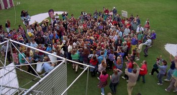 Movie still from “Happy Gilmore” (1996), directed by Dennis Dugan – A crowd of people gathered on a field; Extreme Wide shot, High angle