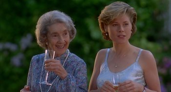 Movie still from “Happy Gilmore” (1996), directed by Dennis Dugan – A woman and an older woman holding wine glasses; Close Up shot, Over the shoulder angle
