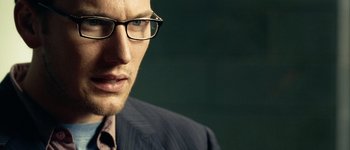 Movie still from “Hard Candy” (2005), directed by David Slade – A person wearing glasses and a suit; Close Up shot, Over the shoulder angle