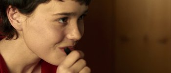 A young boy brushing his teeth with an electric toothbrush
