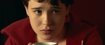 Movie still from “Hard Candy” (2005), directed by David Slade – A boy is holding a coffee cup in his hand; Extreme Close Up shot, High angle