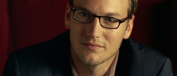 Movie still from “Hard Candy” (2005), directed by David Slade – A person wearing glasses and a suit; Close Up shot, Over the shoulder angle