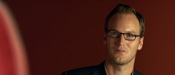 Movie still from “Hard Candy” (2005), directed by David Slade – A person wearing glasses and a suit; Close Up shot, High angle