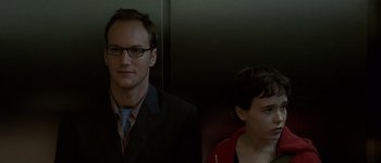 Movie still from “Hard Candy” (2005), directed by David Slade – A man and a woman standing next to each other in front of an elevator; Close Up shot, Over the shoulder angle