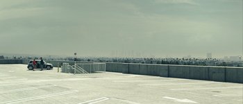 Movie still from “Hard Candy” (2005), directed by David Slade – A parking lot with a fence and stairs leading up to it; Extreme Wide shot, High angle