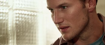 Movie still from “Hard Candy” (2005), directed by David Slade – A man's face with a building in the background; Close Up shot, Low angle