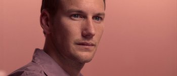 Movie still from “Hard Candy” (2005), directed by David Slade – A man's face in front of a pink wall; Close Up shot, Low angle