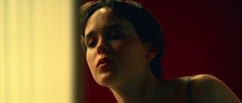 Movie still from “Hard Candy” (2005), directed by David Slade – A woman's face in a red room; Close Up shot, Low angle