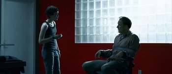 Movie still from “Hard Candy” (2005), directed by David Slade – A man and a woman are talking in front of a window; Medium shot, Over the shoulder angle