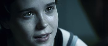 Movie still from “Hard Candy” (2005), directed by David Slade – A woman's face with a dark background; Extreme Close Up shot, Over the shoulder angle