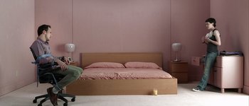 Movie still from “Hard Candy” (2005), directed by David Slade – A bedroom with a bed , two lamps , and a dresser; Wide shot, High angle