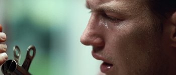Movie still from “Hard Candy” (2005), directed by David Slade – A man's face with tears in his eyes; Extreme Close Up shot, Low angle